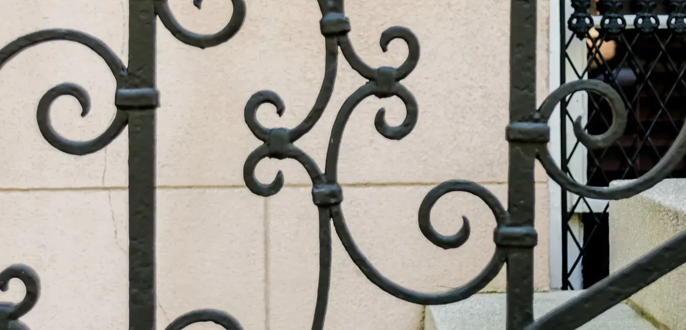 Black wrought-iron style staircase railing with scrollwork
