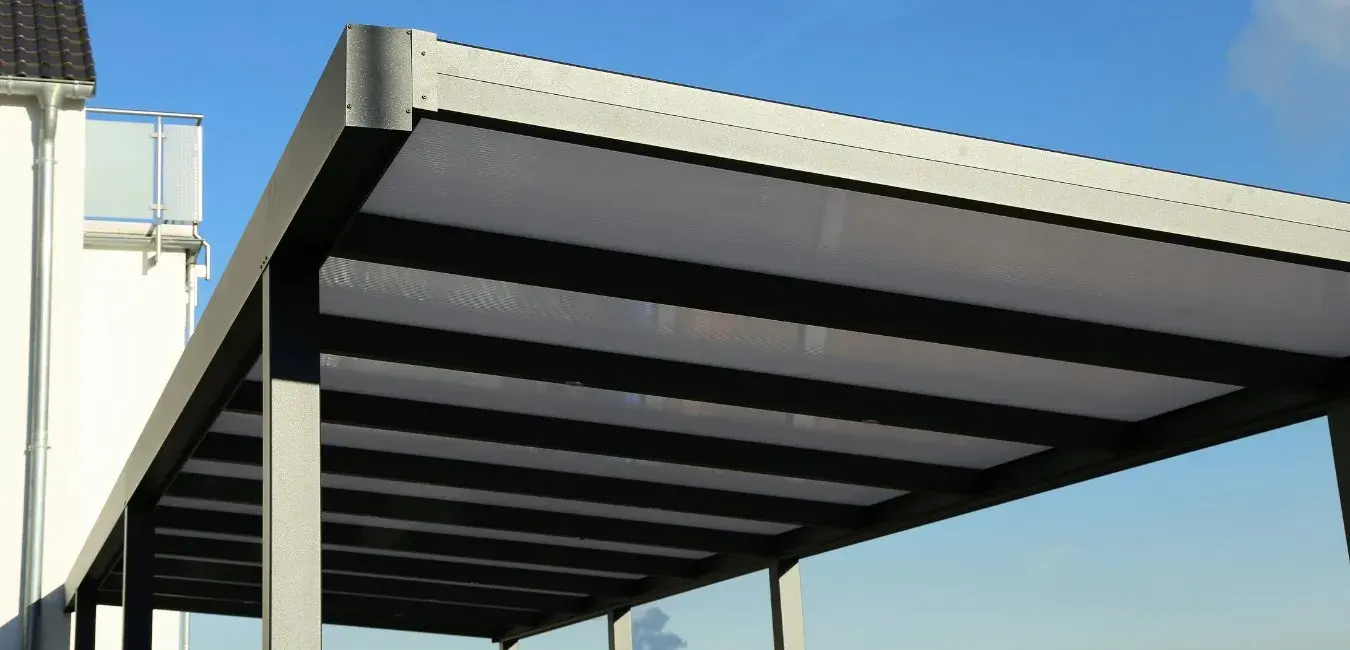 Steel carport with translucent polycarbonate roof sheeting