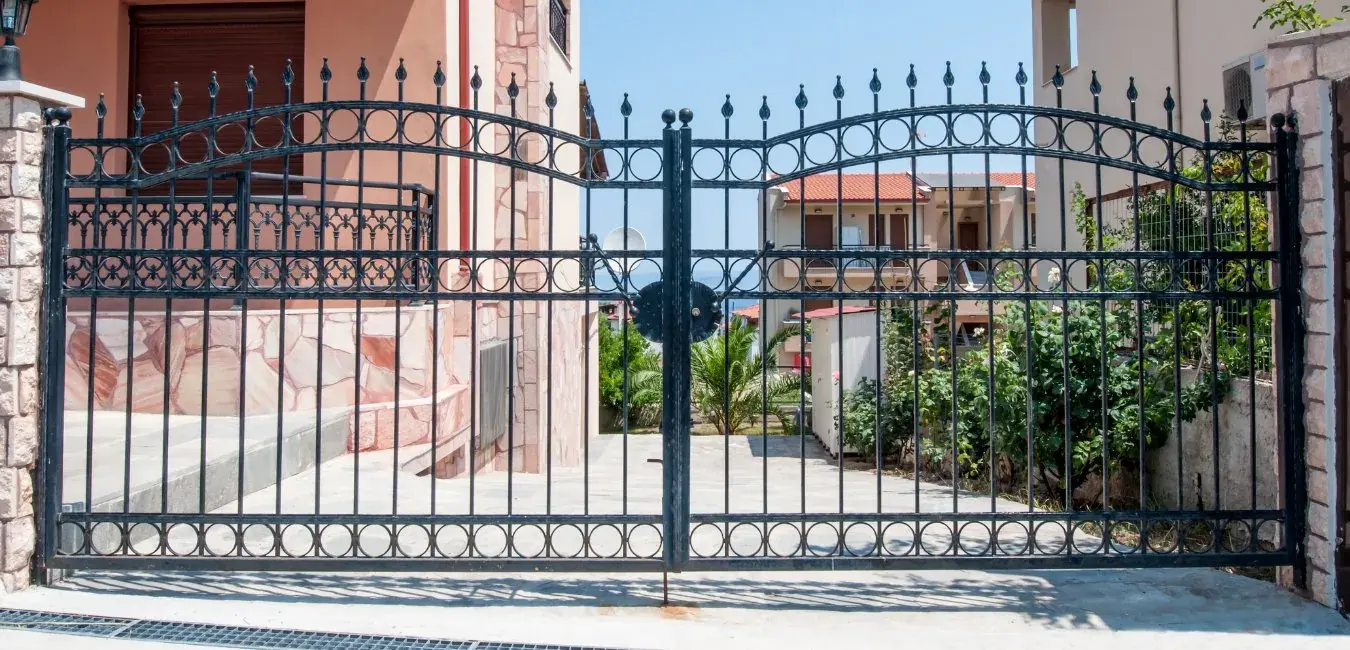 Double swing steel driveway gate with spear tops and ring detailing
