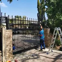 Recent job: steel driveway gate being finished between face-brick pillars